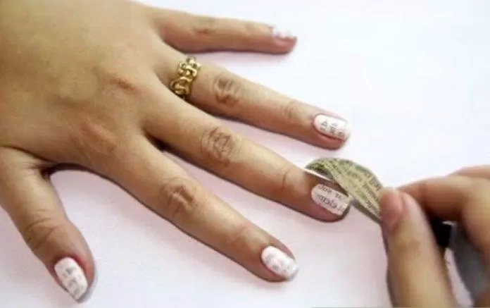 Nhẹ nhàng gỡ giấy báo vừa dán ra khỏi móng tay gỡ giấy báo