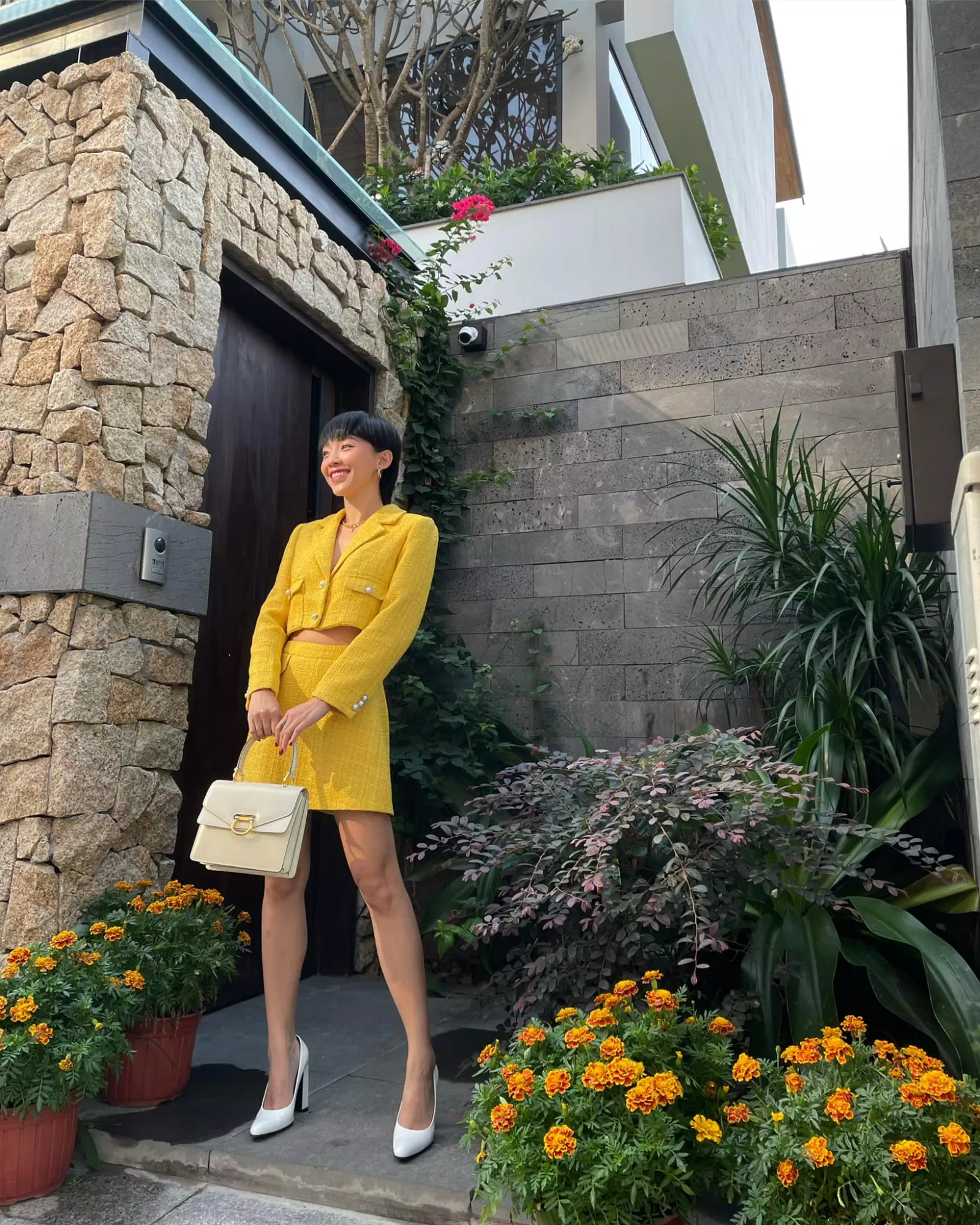 Set đồ vải tweed được phối cùng giầy cao gót và túi xách tông trắng và be (Nguồn: Internet) Set đồ vải tweed được phối cùng giầy cao gót và túi xách tông trắng và be (Nguồn: Internet)