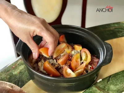 Cho các gia vị và cà chua vào nồi cá (Nguồn: BlogAnChoi).