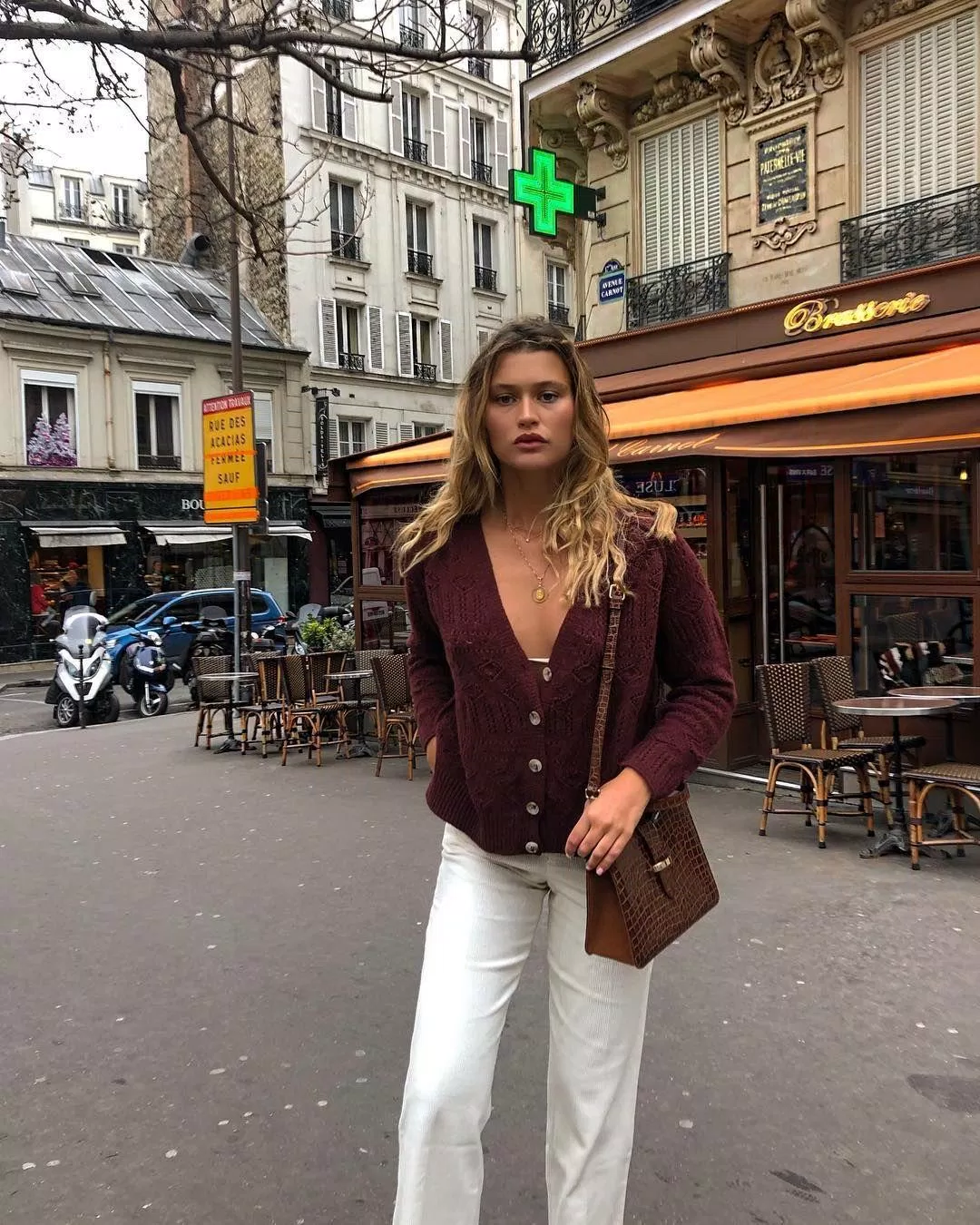 Cardigan nâu đỏ trầm cổ điển "ăn rơ" với quần suông trắng. (nguồn ảnh: Internet) Cardigan nâu đỏ trầm cổ điển "ăn rơ" với quần suông trắng. (nguồn ảnh: Internet)